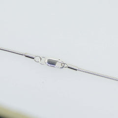 Close-up of a sterling silver snake chain necklace clasp, showcasing 925 rhodium-plated metal finish.