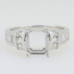 Sterling silver semi mount ring setting for 9X7mm emerald, featuring white topaz accents and polished finish.