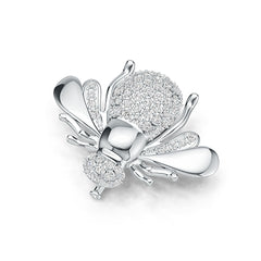 Silver bee-shaped jewelry piece with clear gemstones on a white background