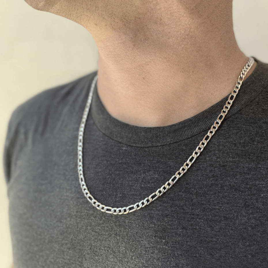 Sterling Silver Figaro chain necklace worn by a model, showcasing its 5mm width and 16-24 inch length options.