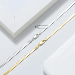Close-up of 3mm Sterling Silver and Gold Snake Bone Chain clasps on a minimalist background, showcasing elegance.