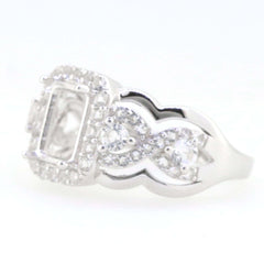 Sterling silver semi mount ring setting with crisscross swirl shank, designed for 8x6mm emerald and white topaz accents.