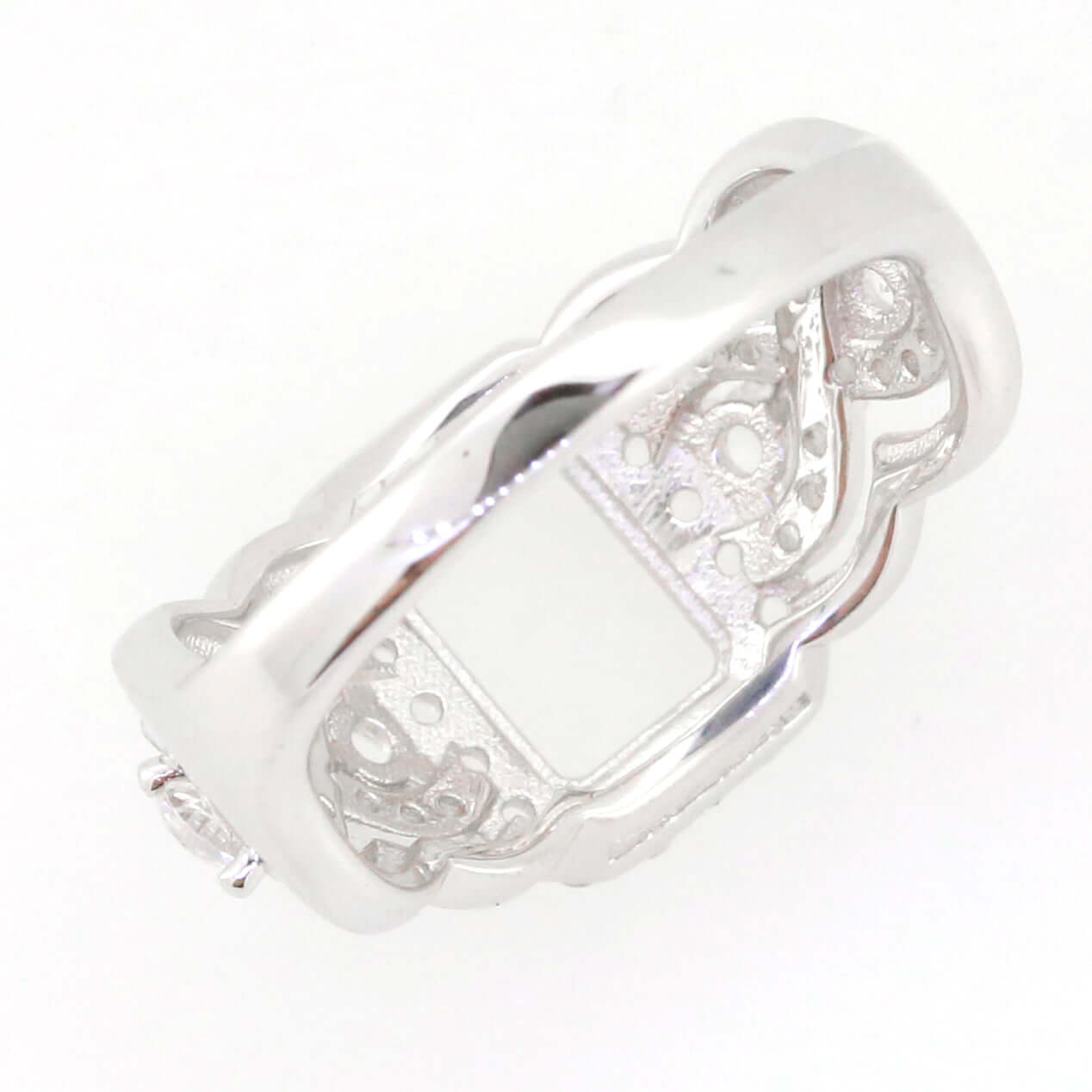 Sterling silver semi mount ring setting with crisscross swirl shank for 8x6mm emerald, white topaz accents.