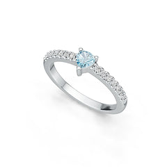 Silver ring with a central blue gemstone and smaller diamonds on a white background